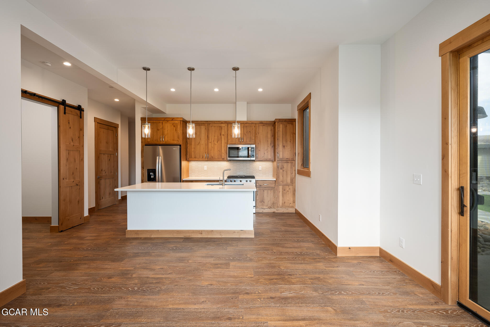 96 Meadow Trail, Unit G101 Fraser, CO 80442 - Photo 4 of 19 a view of kitchen with kitchen island wooden floor center island and stainless steel appliances