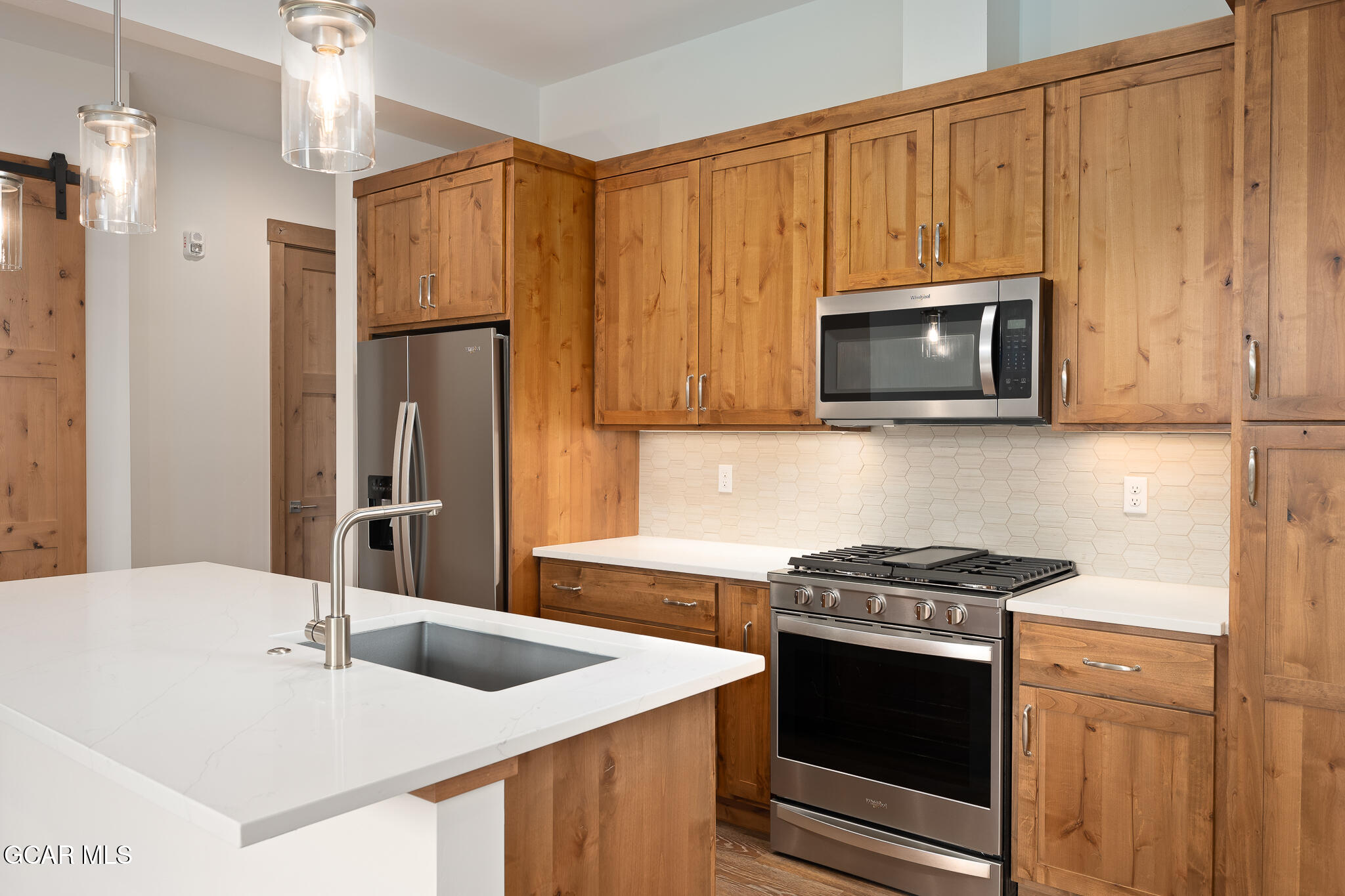 96 Meadow Trail, Unit G101 Fraser, CO 80442 - Photo 5 of 19 a kitchen with stainless steel appliances granite countertop a sink and a microwave