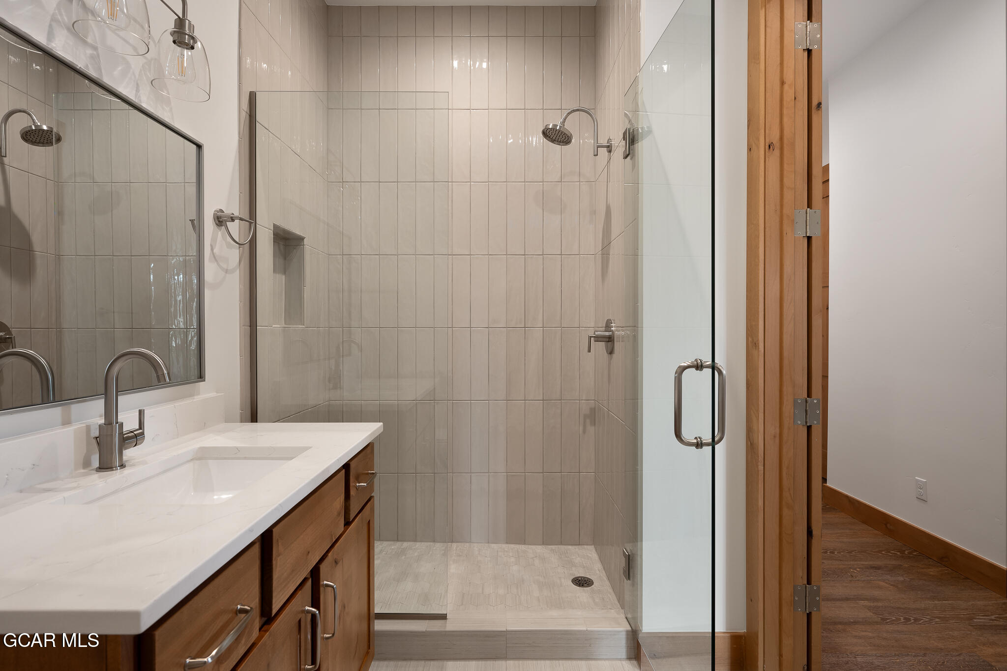 96 Meadow Trail, Unit G101 Fraser, CO 80442 - Photo 9 of 19 a bathroom with a sink shower and a mirror