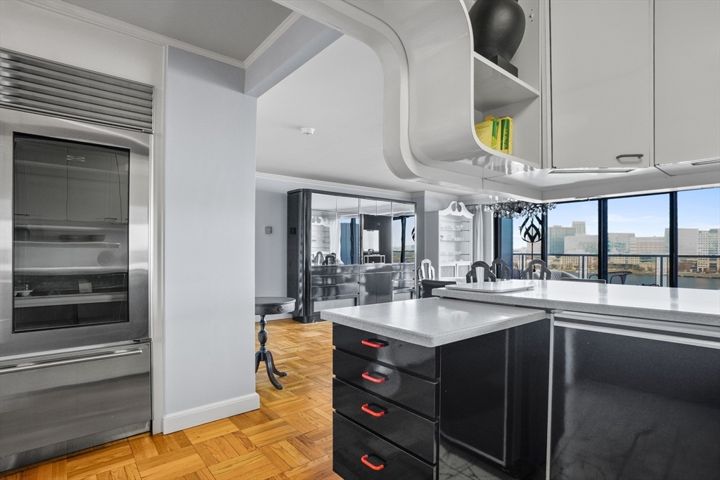 180 Beacon Street, Unit 14FG Boston, MA 02116 - Photo 15 of 40 a kitchen with stainless steel appliances granite countertop a sink and stove