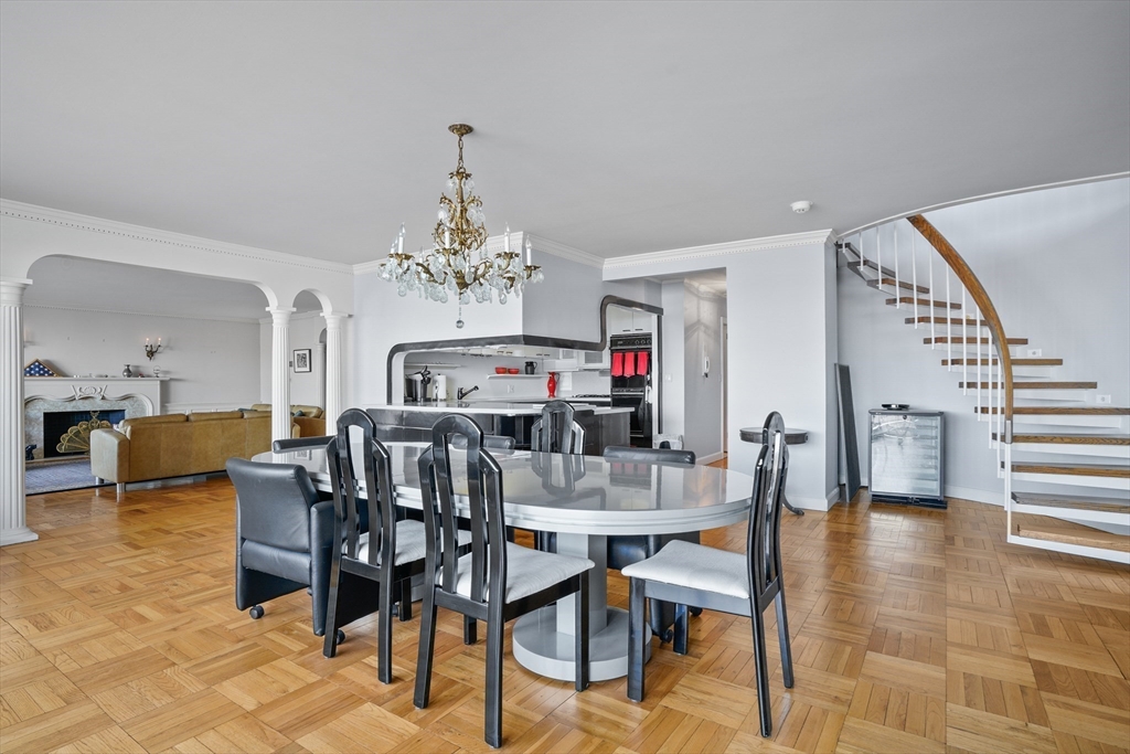 180 Beacon Street, Unit 14FG Boston, MA 02116 - Photo 16 of 40 a view of a dining room with furniture