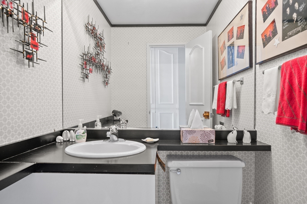 180 Beacon Street, Unit 14FG Boston, MA 02116 - Photo 17 of 40 a bathroom with a granite countertop sink a mirror and a shower curtain
