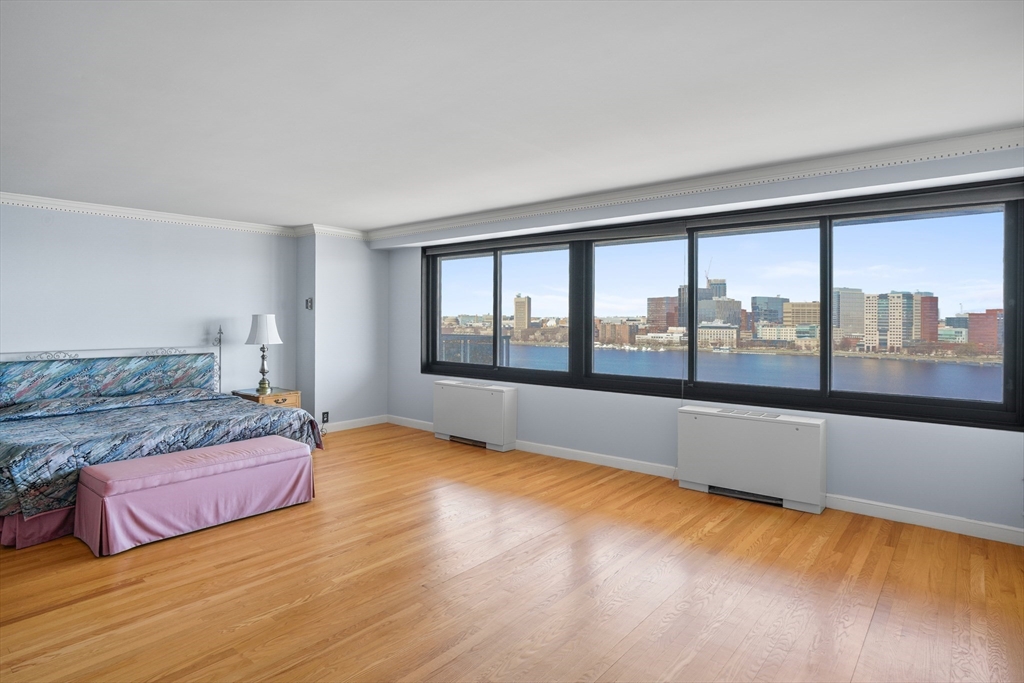 180 Beacon Street, Unit 14FG Boston, MA 02116 - Photo 19 of 40 a spacious bedroom with a large bed and a large window