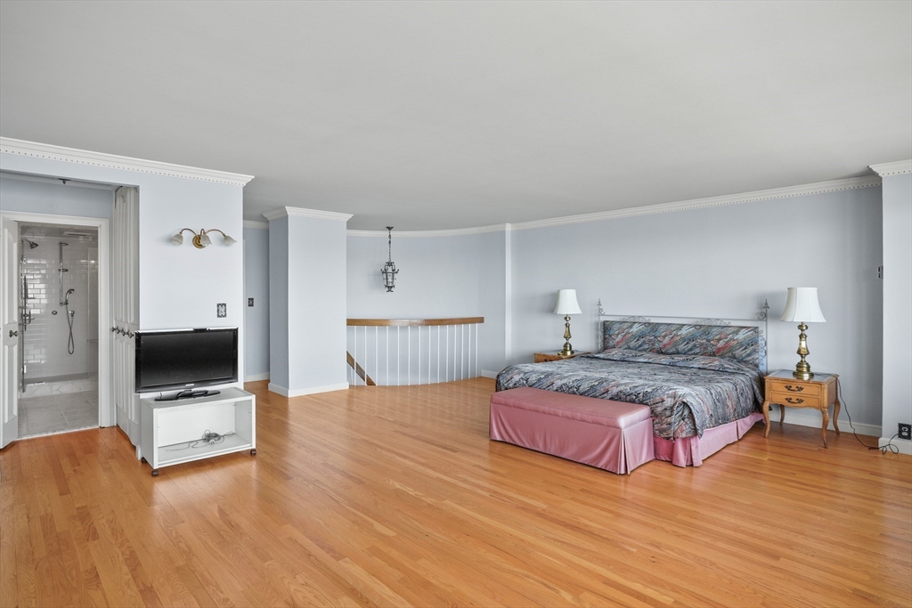 180 Beacon Street, Unit 14FG Boston, MA 02116 - Photo 20 of 40 a bedroom with a bed and a flat screen tv