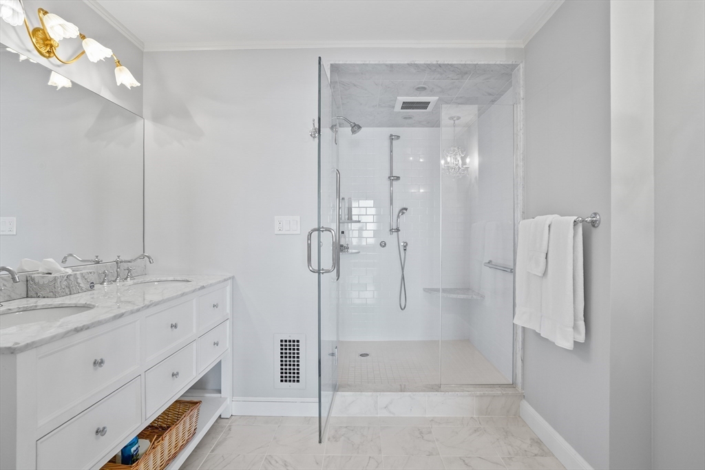 180 Beacon Street, Unit 14FG Boston, MA 02116 - Photo 21 of 40 a bathroom with a granite countertop sink mirror and shower