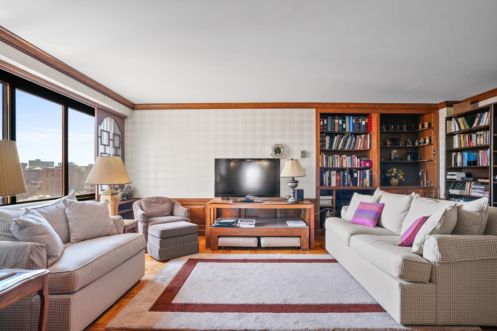 180 Beacon Street, Unit 14FG Boston, MA 02116 - Photo 25 of 40 a living room with furniture and a floor to ceiling window