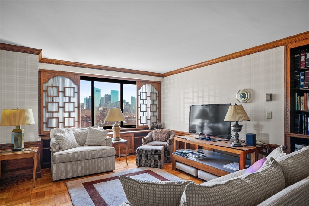 180 Beacon Street, Unit 14FG Boston, MA 02116 - Photo 26 of 40 a living room with furniture and a flat screen tv