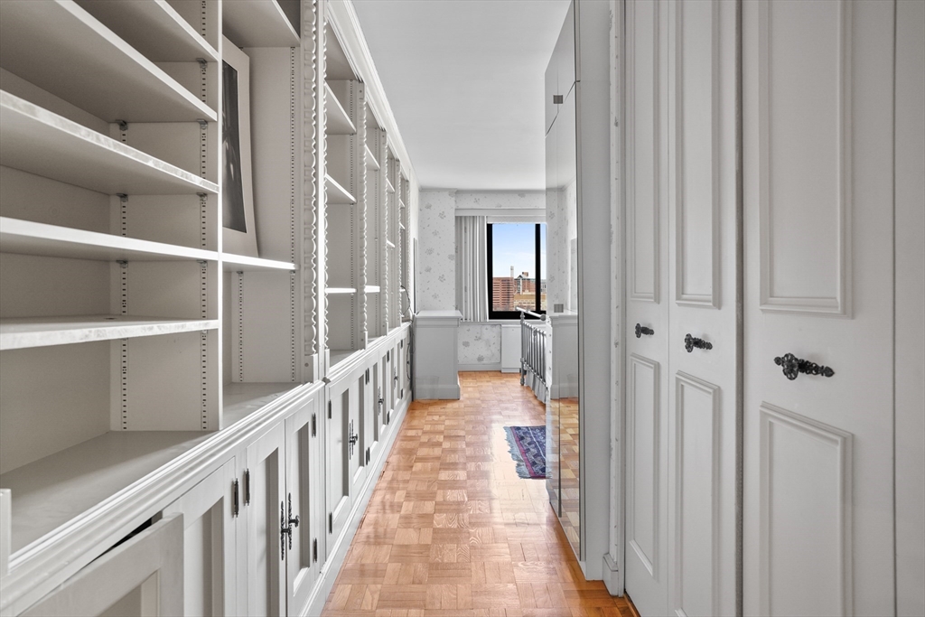 180 Beacon Street, Unit 14FG Boston, MA 02116 - Photo 28 of 40 a view of a hallway with wooden floor and staircase