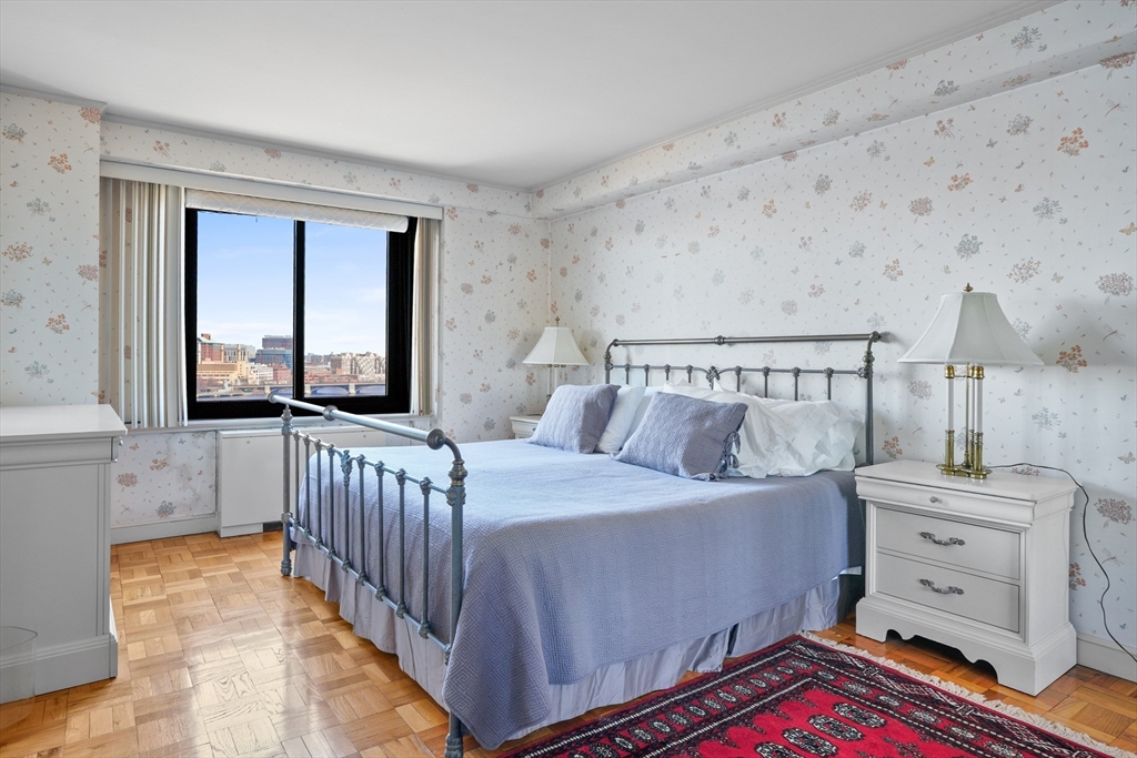 180 Beacon Street, Unit 14FG Boston, MA 02116 - Photo 29 of 40 a bedroom with a bed and a window