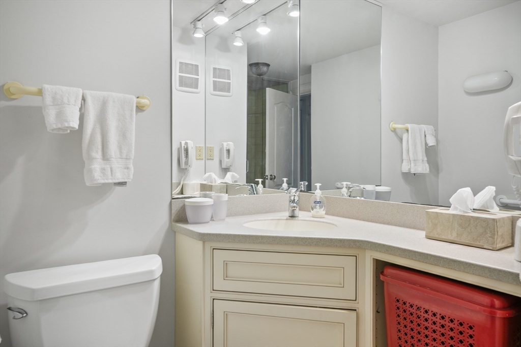 180 Beacon Street, Unit 14FG Boston, MA 02116 - Photo 32 of 40 a bathroom with a sink a toilet and a mirror