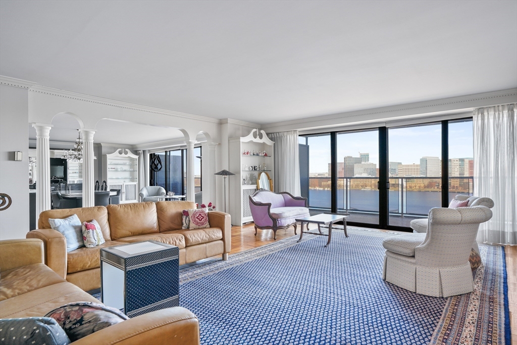 180 Beacon Street, Unit 14FG Boston, MA 02116 - Photo 4 of 40 a living room with furniture and a large window