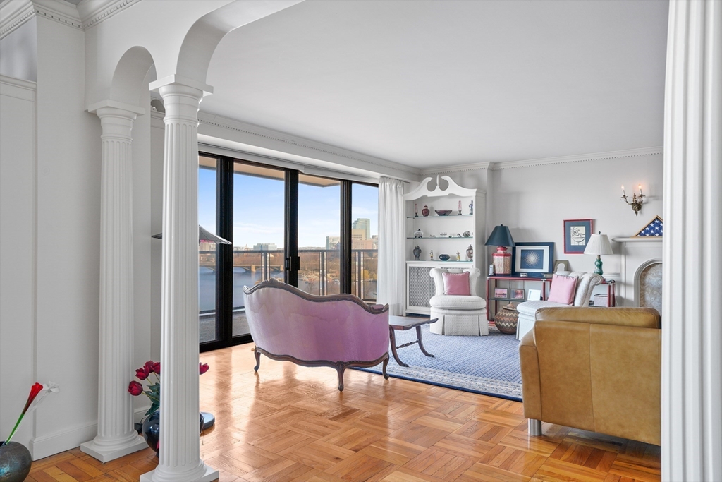 180 Beacon Street, Unit 14FG Boston, MA 02116 - Photo 7 of 40 a living room with furniture and a floor to ceiling window