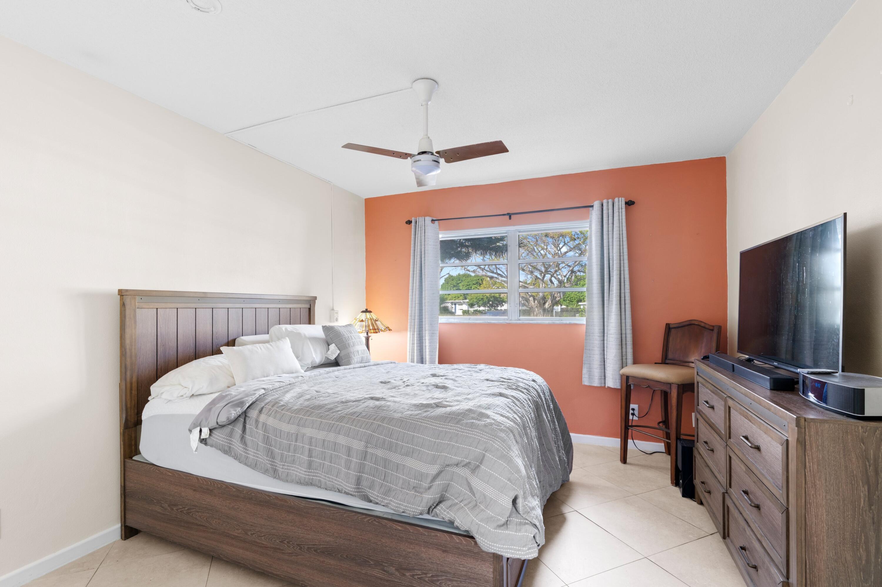 300 Northeast 20th Street, Unit 109 Boca Raton, FL 33431 - Photo 11 of 36 a bedroom with a bed and a flat screen tv