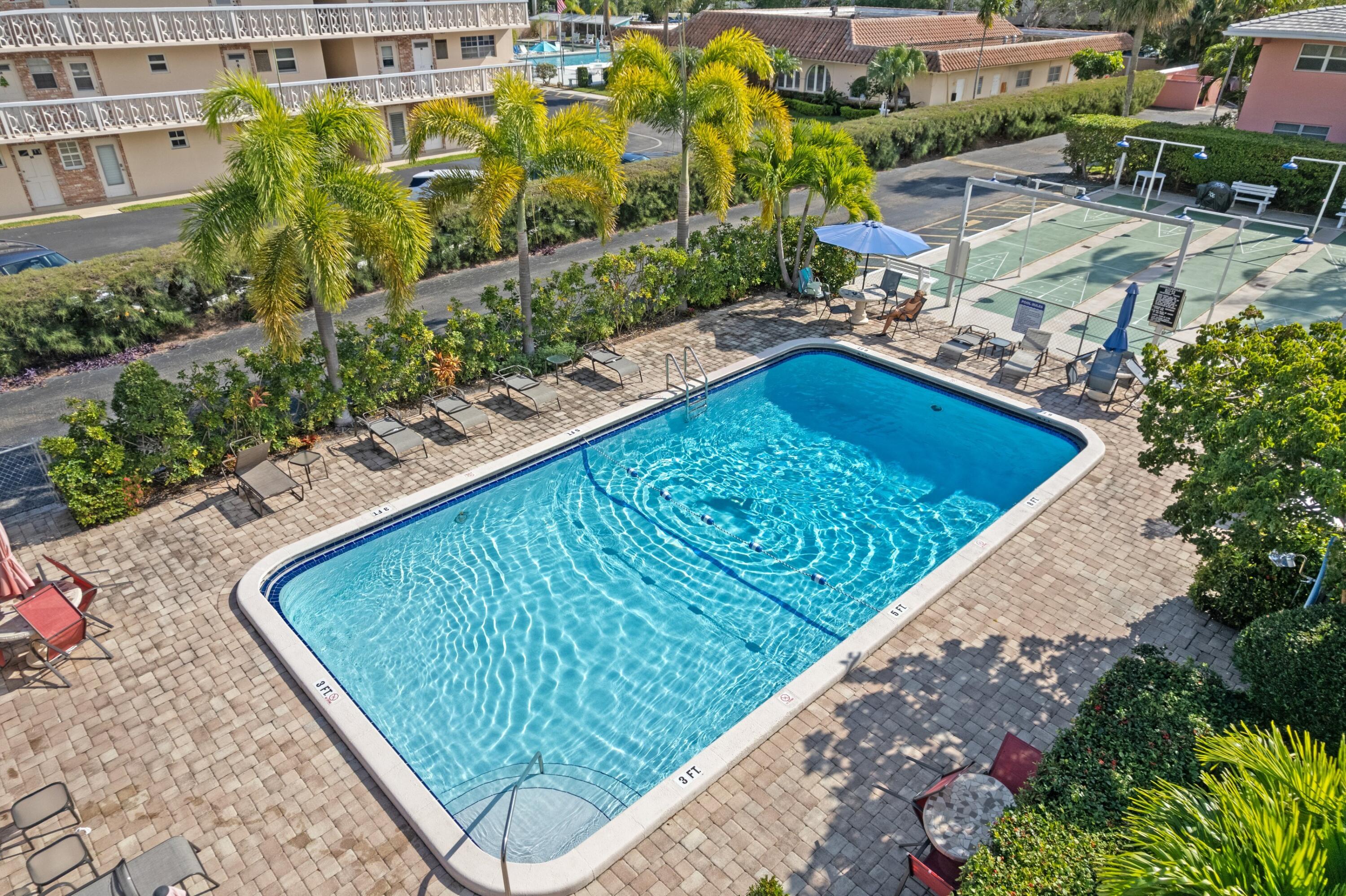300 Northeast 20th Street, Unit 109 Boca Raton, FL 33431 - Photo 15 of 36 a view of a swimming pool with a patio