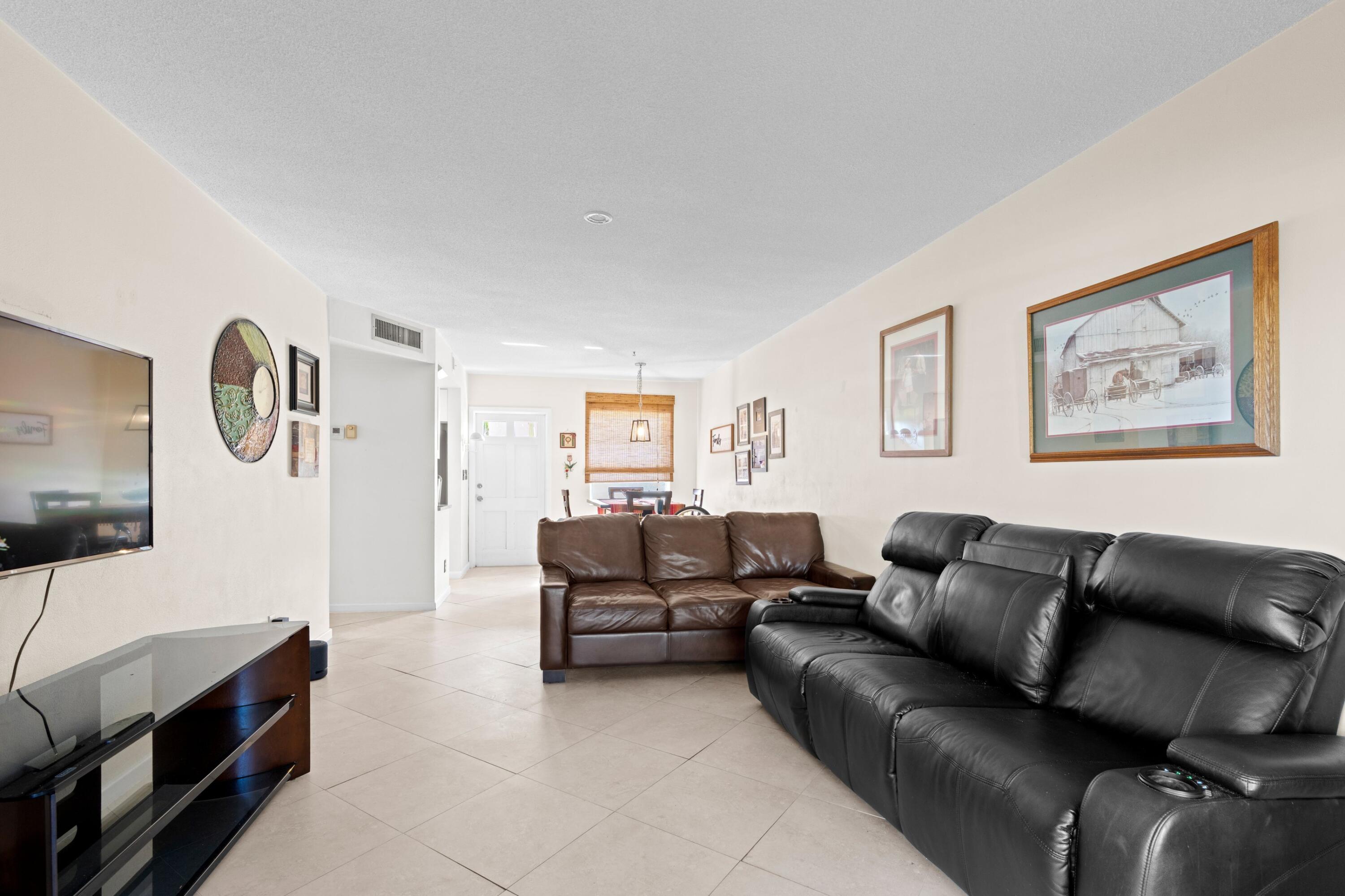 300 Northeast 20th Street, Unit 109 Boca Raton, FL 33431 - Photo 10 of 36 a living room with furniture and a flat screen tv
