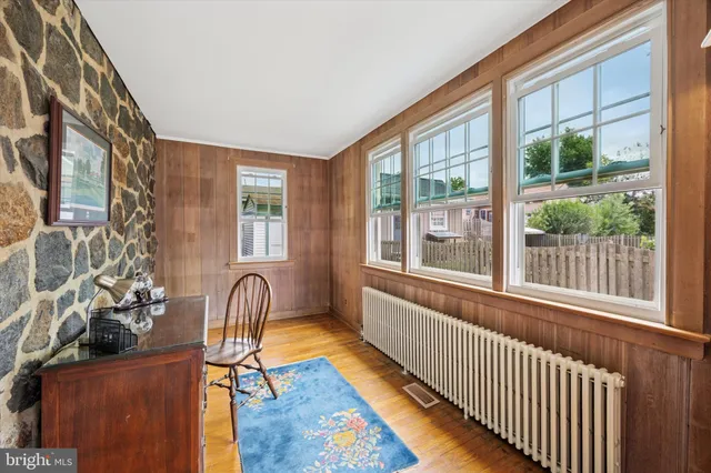 a view of a porch with chairs and barbeque grill with wooden floor