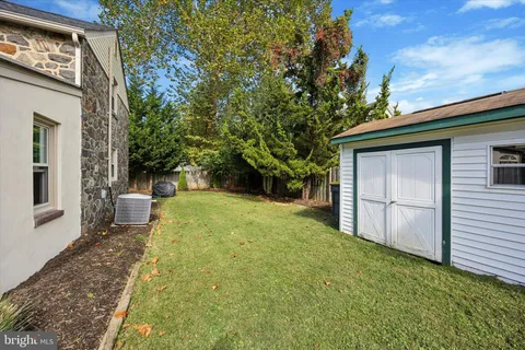 a view of a backyard with large trees