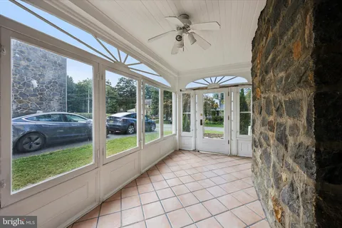 a view of a porch with furniture and garden