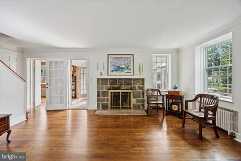 a living room with furniture wooden floor and windows