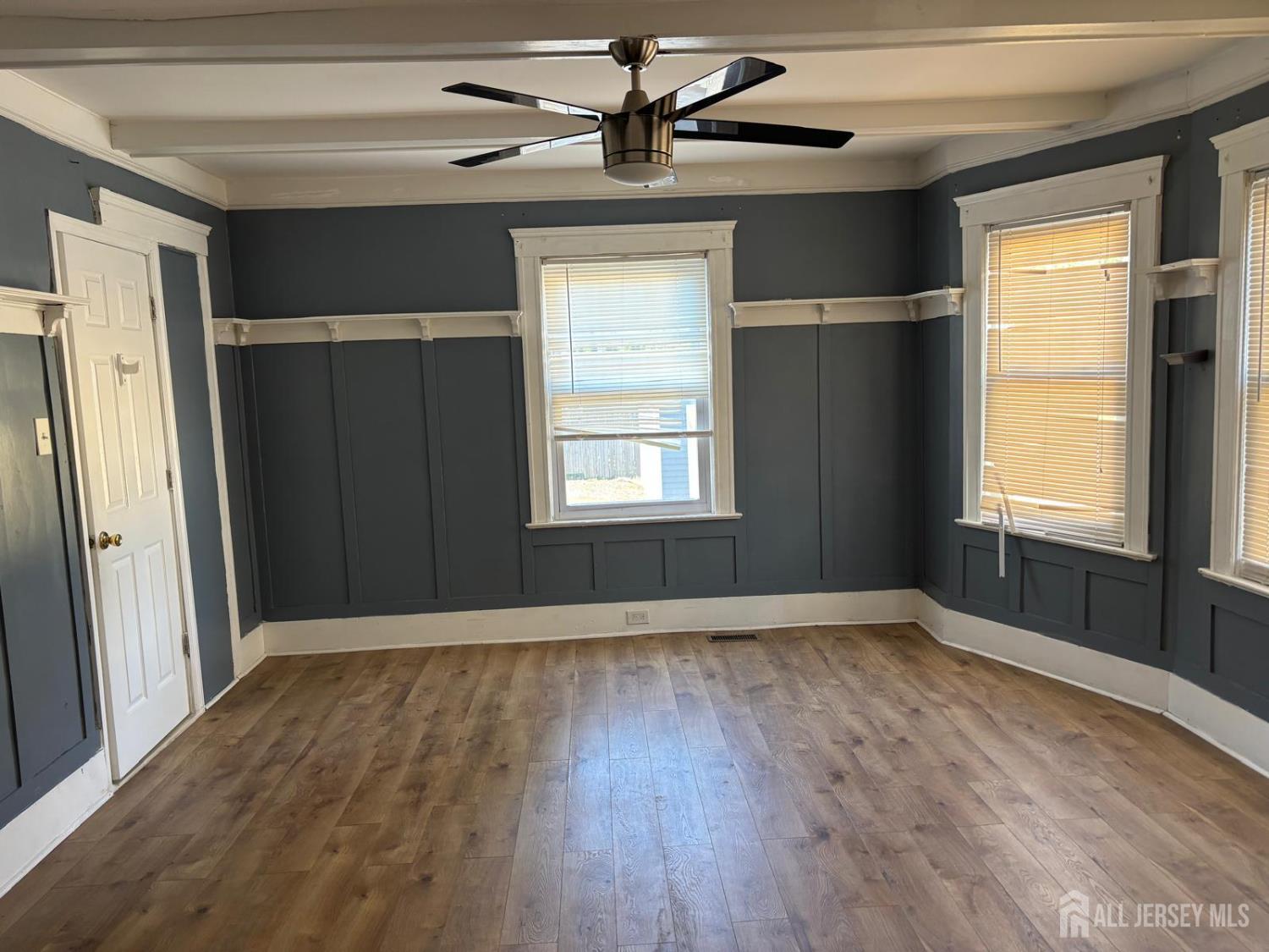 220 South Washington Avenue Dunellen, NJ 08812 - Photo 3 of 11 an empty room with wooden floor closet and windows