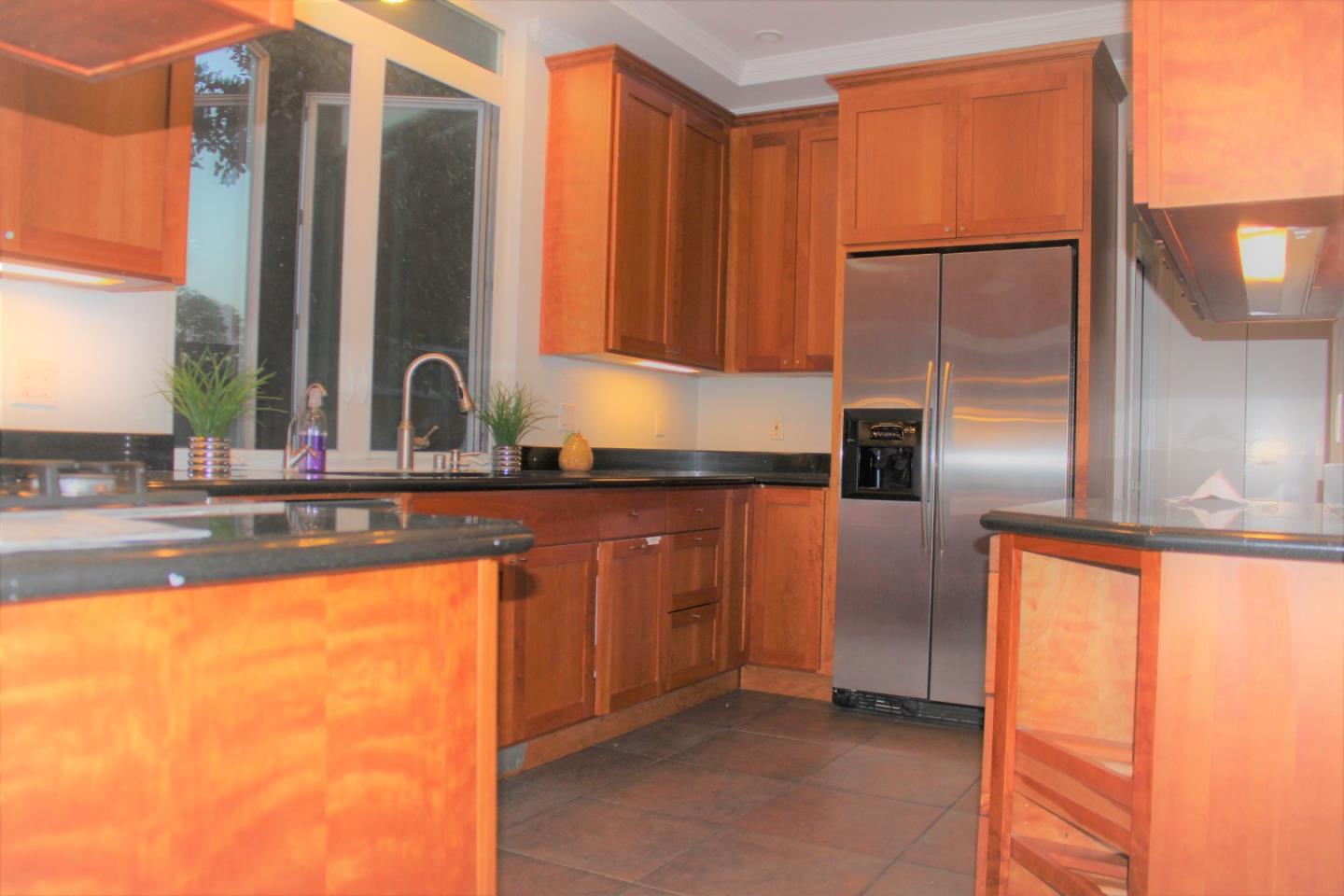 1107 Lautrec Terrace Sunnyvale, CA 94087 - Photo 5 of 16 a kitchen with stainless steel appliances granite countertop a refrigerator and a sink