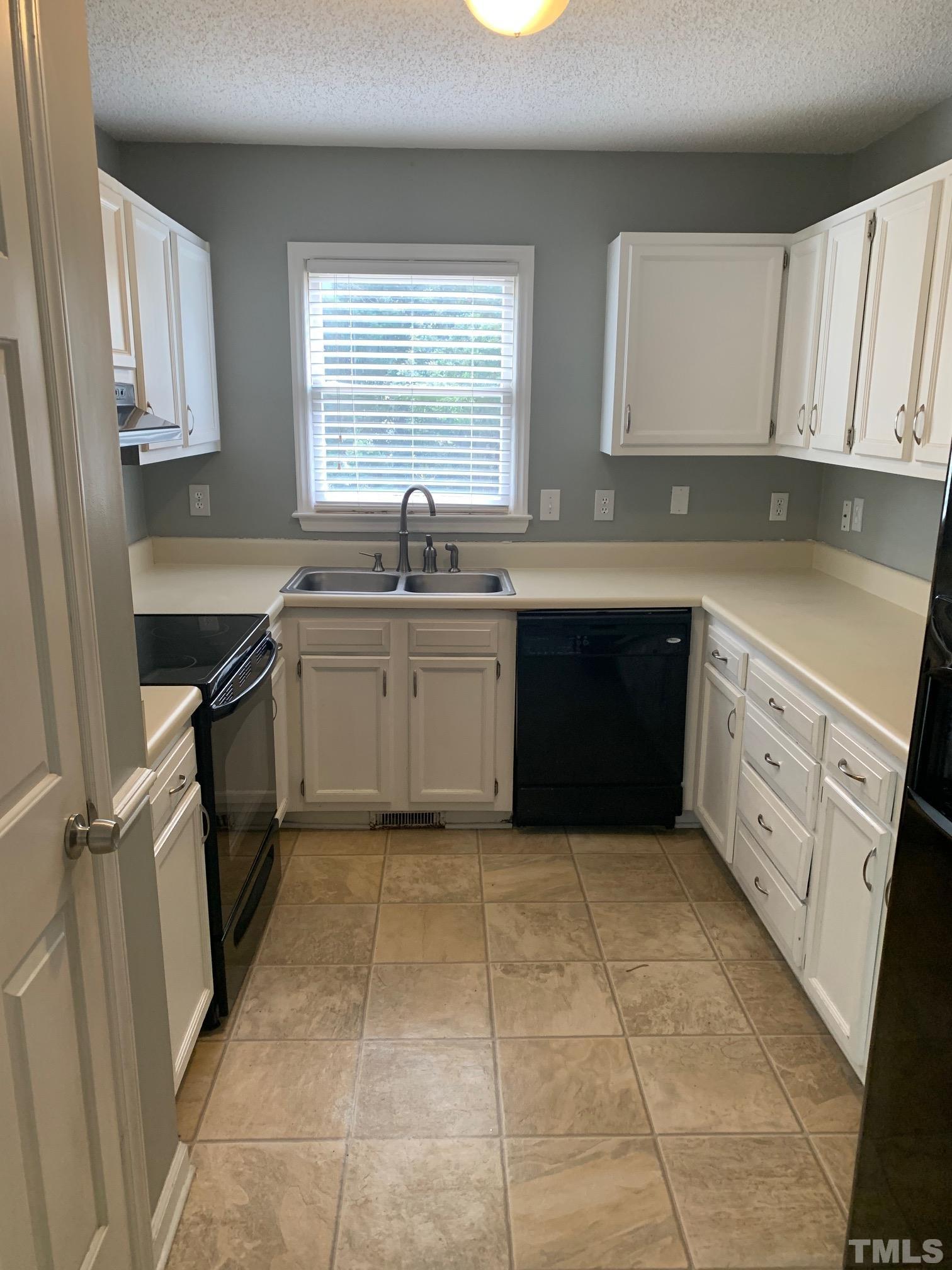 3000 Chippendale Road Raleigh, NC 27604 - Photo 4 of 10 a kitchen with a sink a stove top oven and cabinets