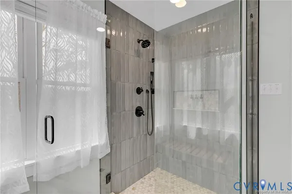 a bedroom with a bed and large window