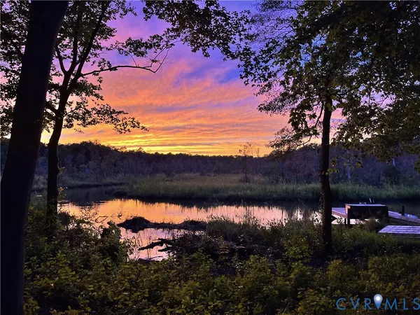 a view of a backyard with chairs and a fire pit
