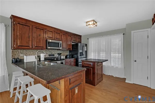a dining room with furniture window and wooden floor