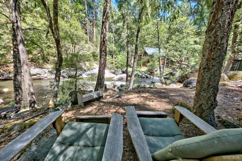 a view of a couches and a table and chairs in the patio