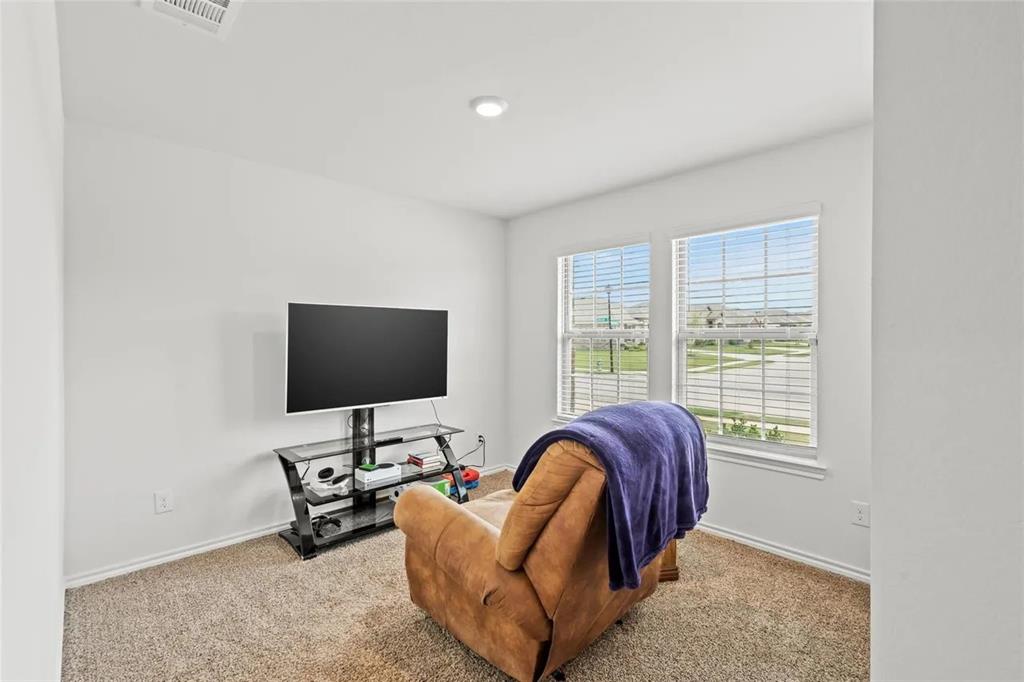 171 Seabiscuit Road Caddo Mills, TX 75135 - Photo 13 of 19 a living room with furniture and a flat screen tv