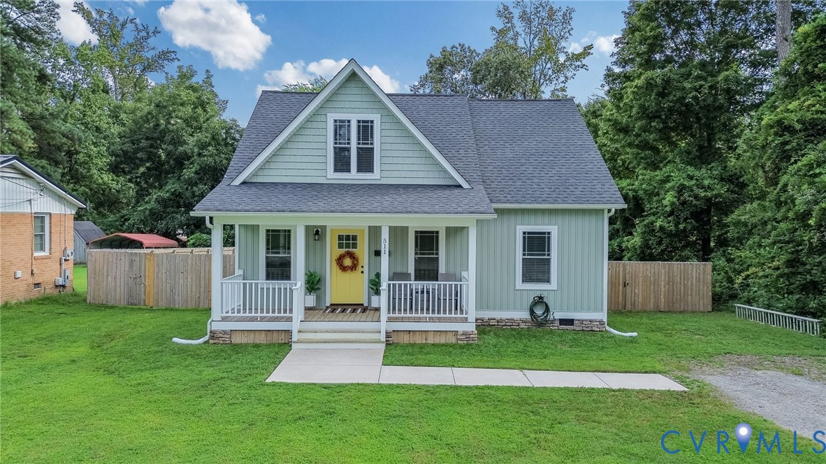a front view of a house with a yard and porch