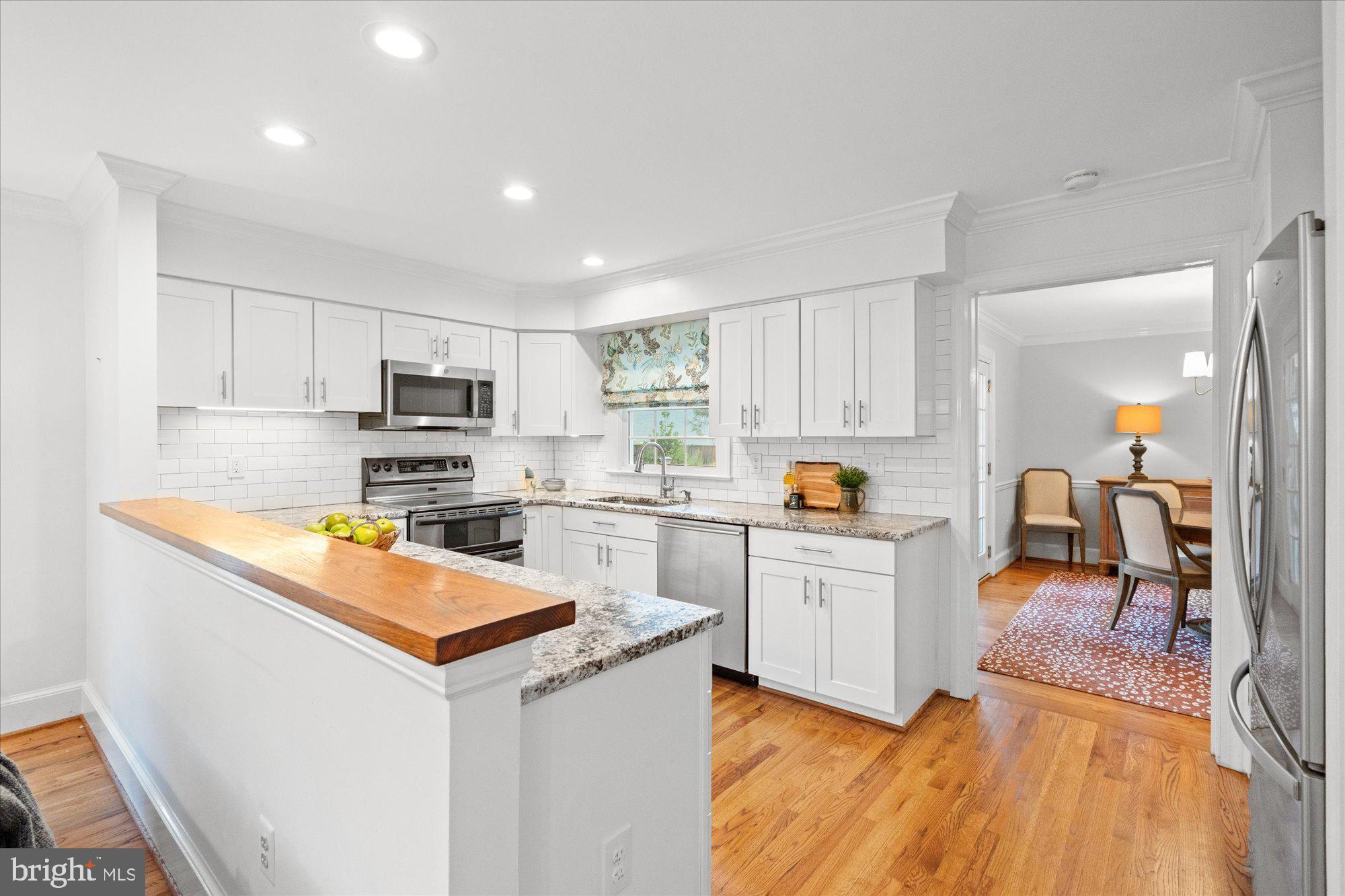 7287 Evans Mill Road McLean, VA 22101 - Photo 11 of 30 a kitchen with white cabinets and appliances