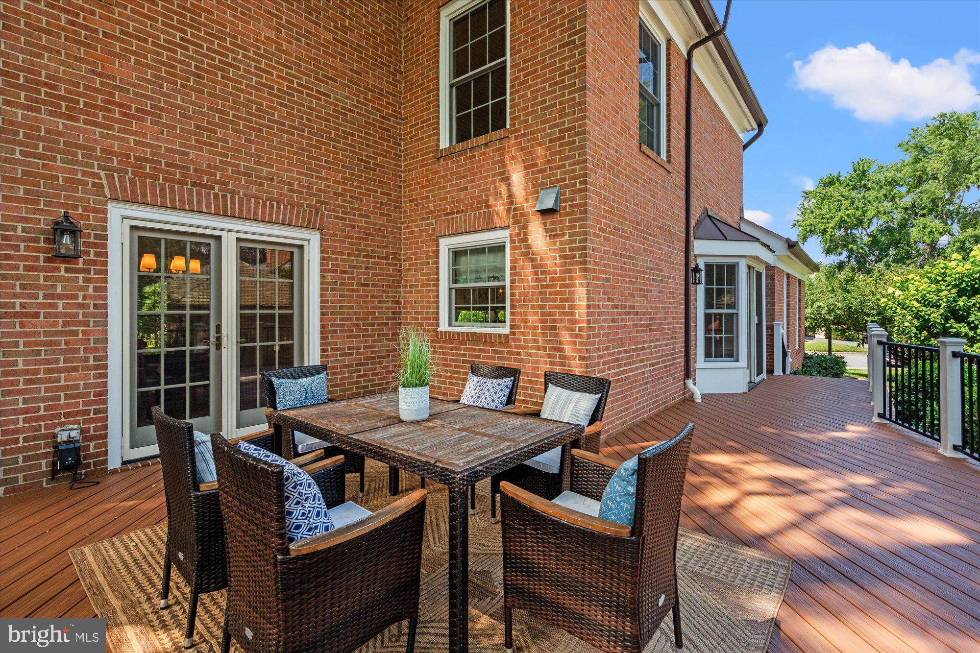 7287 Evans Mill Road McLean, VA 22101 - Photo 14 of 30 a view of a dinning table and chairs in the back yard of the house