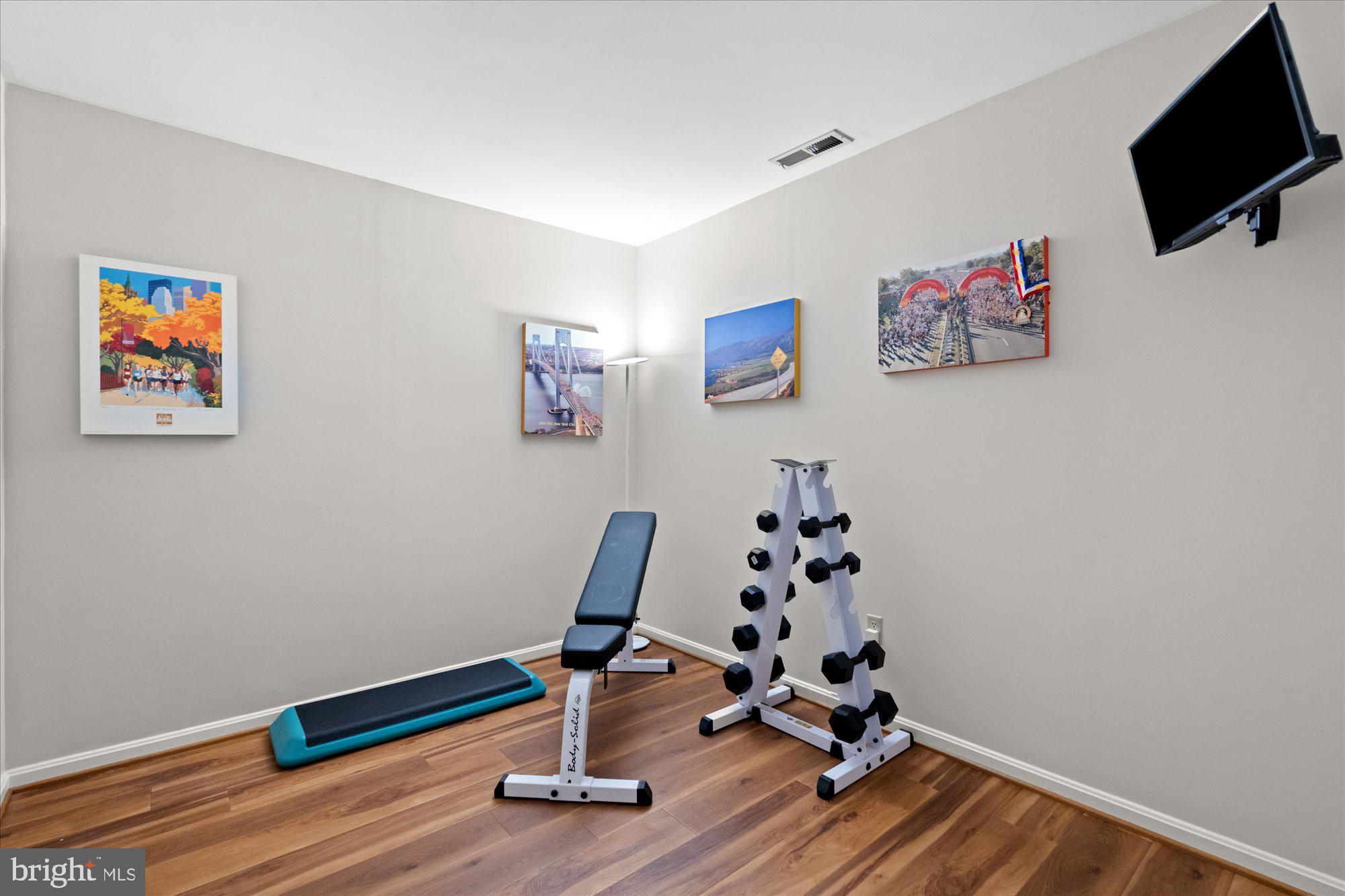 7287 Evans Mill Road McLean, VA 22101 - Photo 27 of 30 a room with gym equipment and wooden floor