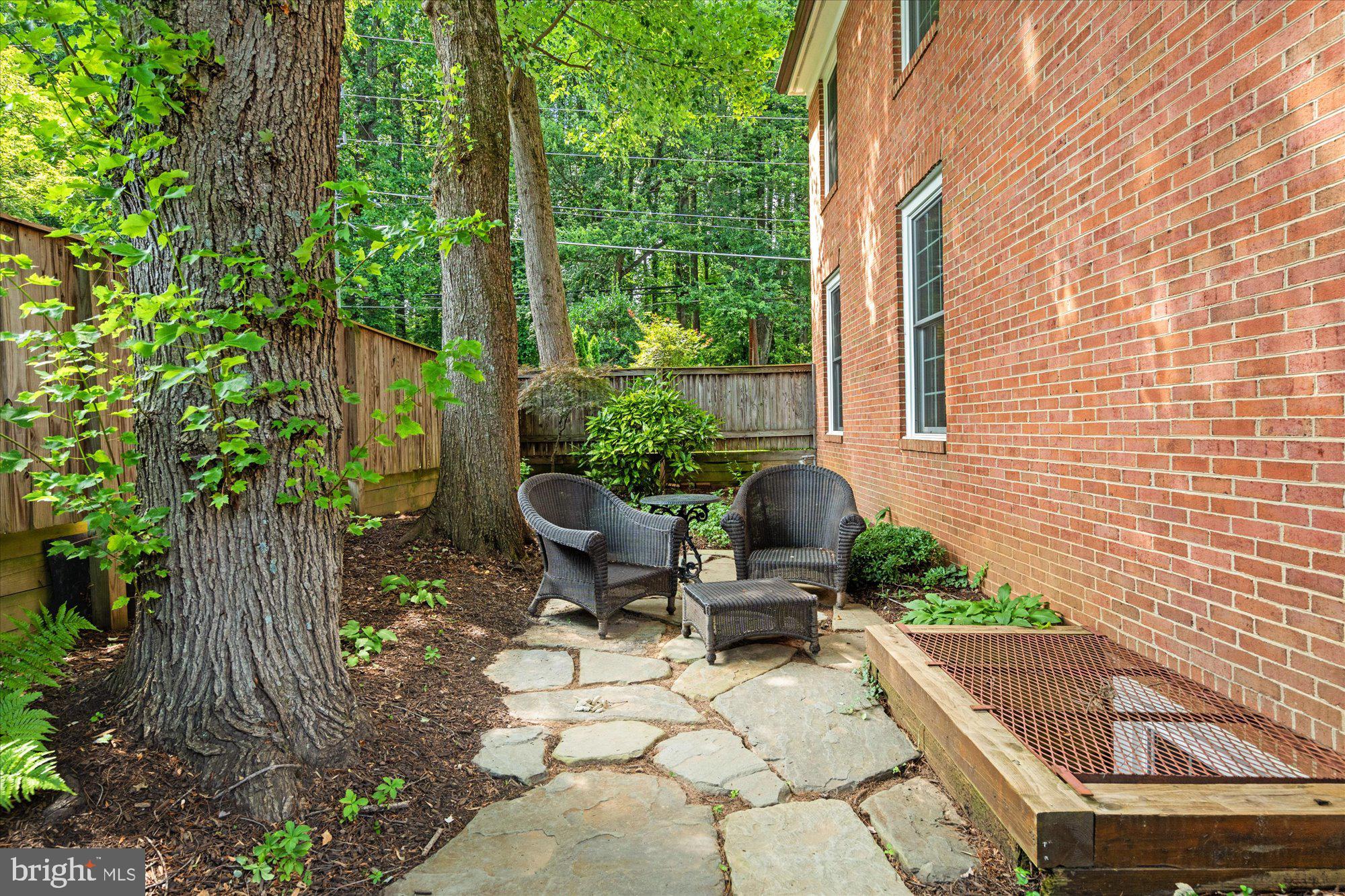 7287 Evans Mill Road McLean, VA 22101 - Photo 29 of 30 a view of a chair and table in backyard of the house