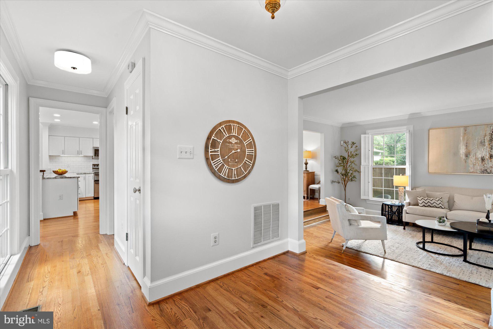 7287 Evans Mill Road McLean, VA 22101 - Photo 4 of 30 a living room with furniture a wooden floor and a large window