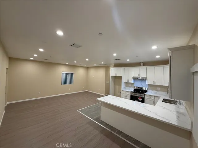 a view of kitchen with refrigerator sink and stove