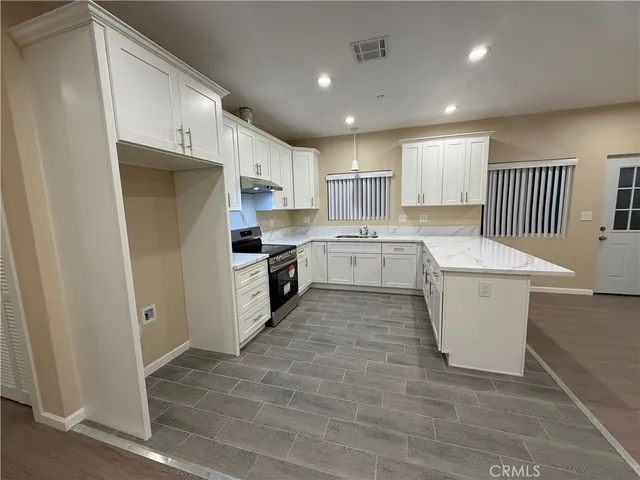 a kitchen with white cabinets and white appliances