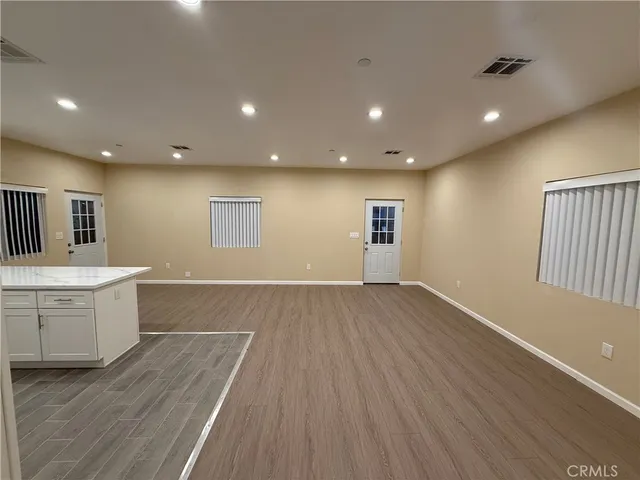 a view of a kitchen with wooden floor and a sink