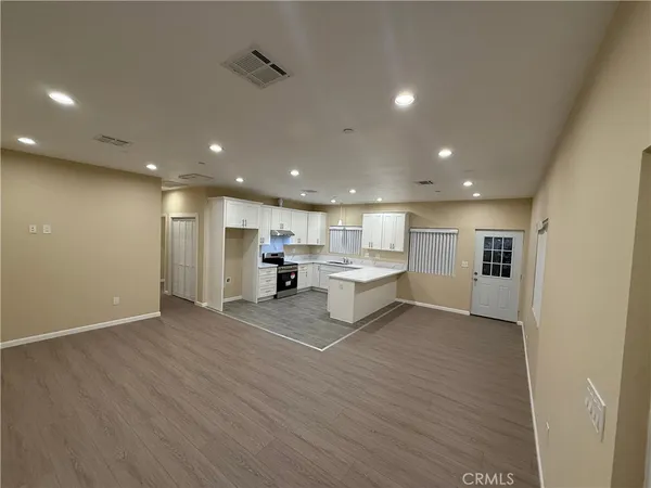 a view of kitchen with stainless steel appliances refrigerator microwave and stove