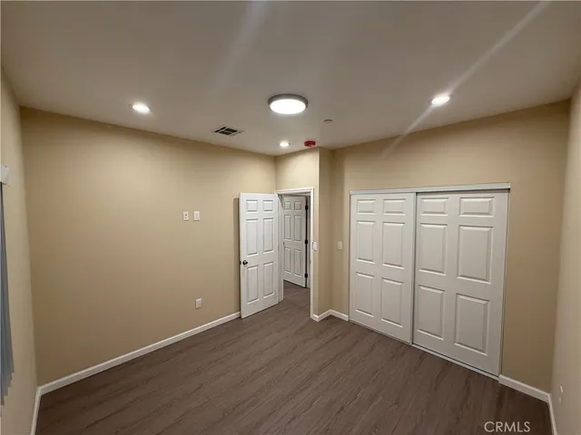 an empty room with wooden floor