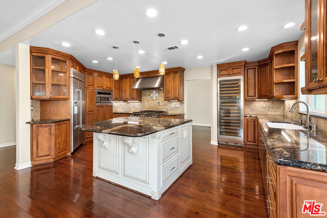 5 Daystar Irvine, CA 92612 - Photo 11 of 52 a kitchen with stainless steel appliances granite countertop a stove and a refrigerator