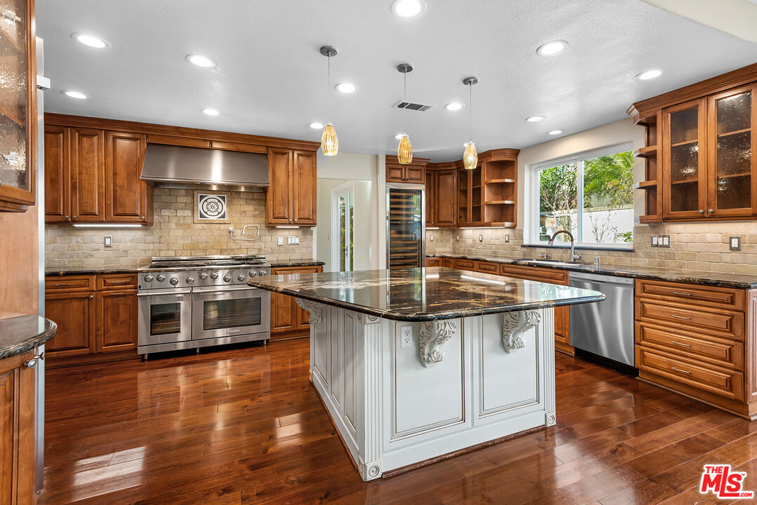5 Daystar Irvine, CA 92612 - Photo 12 of 52 a kitchen with stainless steel appliances granite countertop a stove and a wooden floors