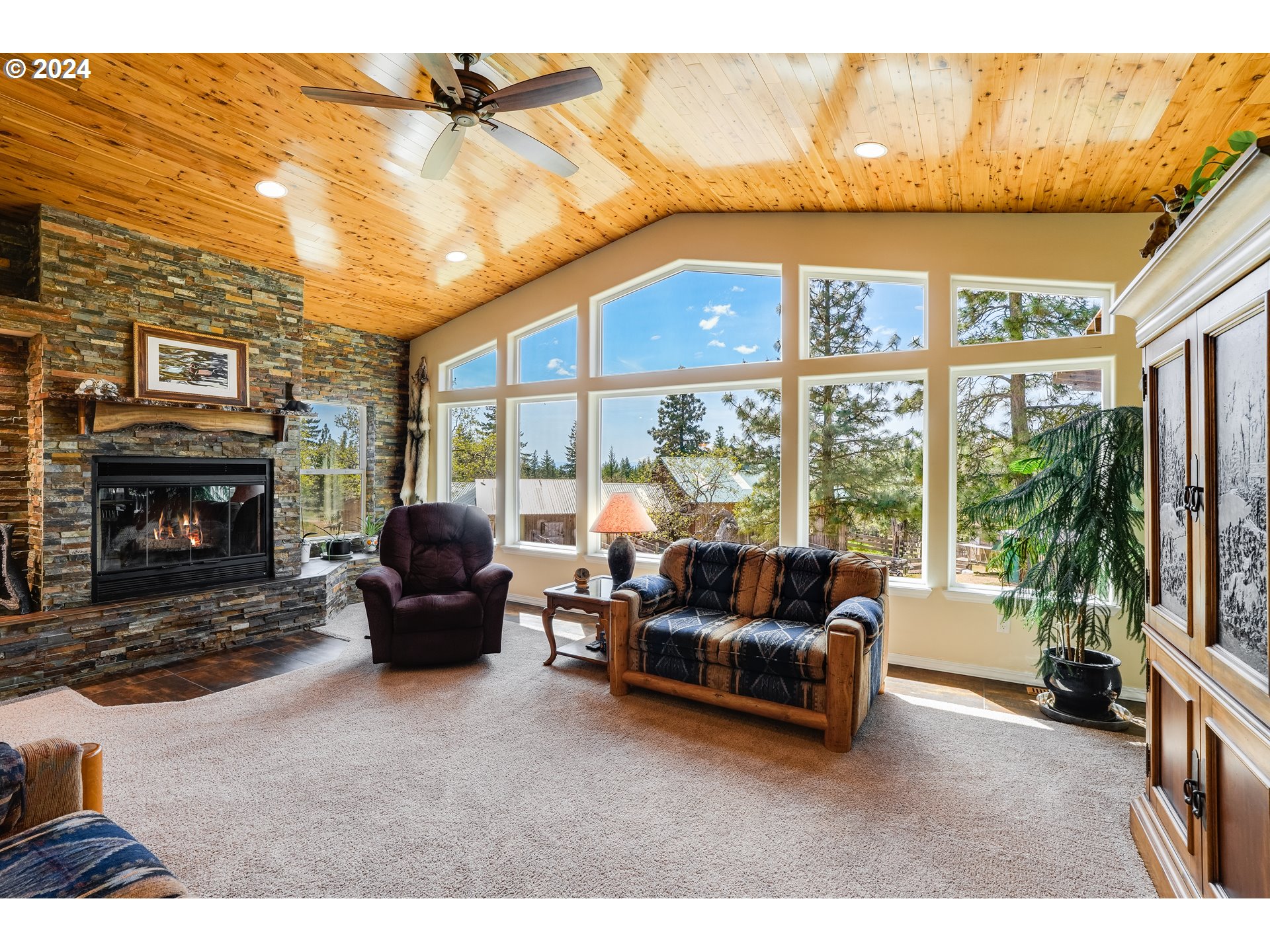 11 Deer Ridge Road Goldendale, WA 98620 - Photo 14 of 45 a living room with furniture a flat screen tv and a fireplace