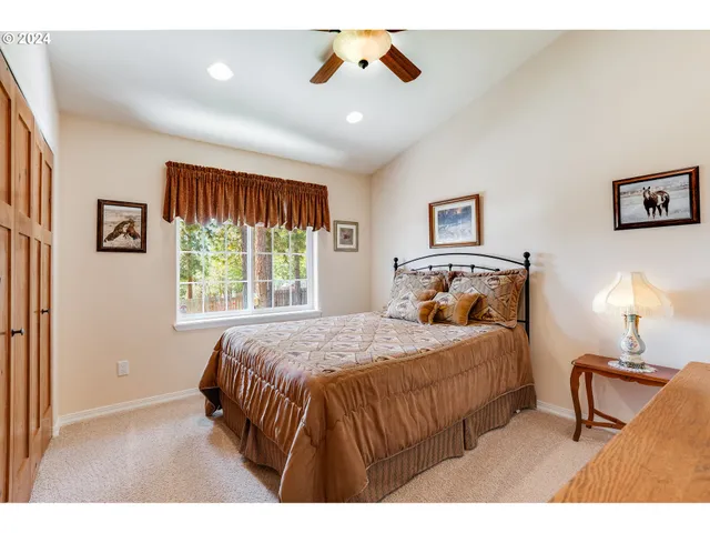 a bedroom with a bed and a lamp