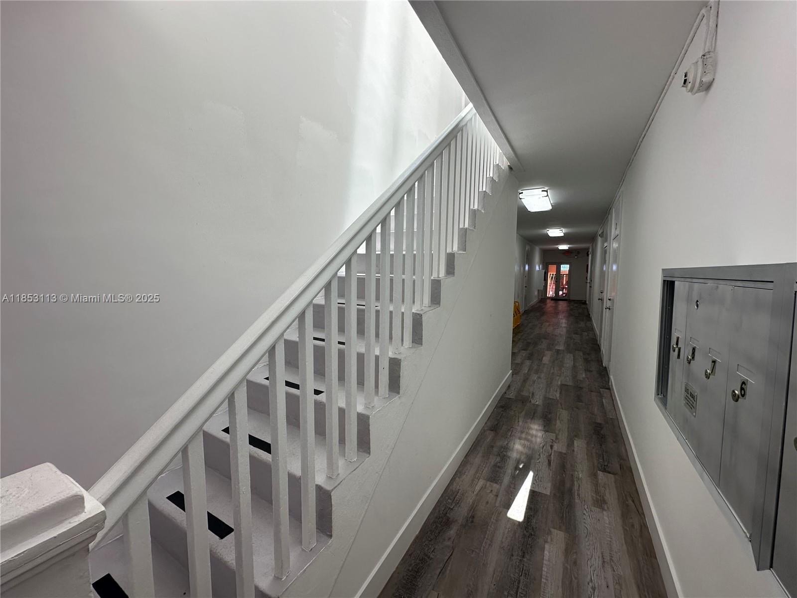 1630 Southwest 10th Street, Unit 8 Miami, FL 33135 - Photo 3 of 14 a view of staircase with wooden floor and white walls