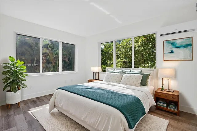 a bedroom with a bed and a large window