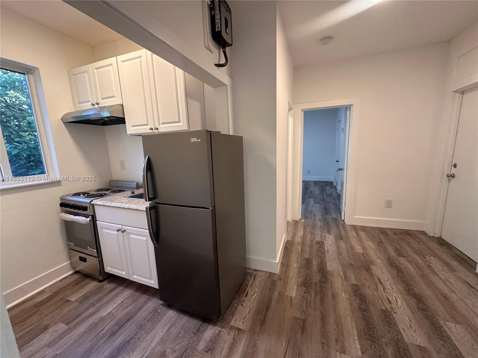 1630 Southwest 10th Street, Unit 8 Miami, FL 33135 - Photo 7 of 14 a kitchen with a refrigerator and a stove top oven