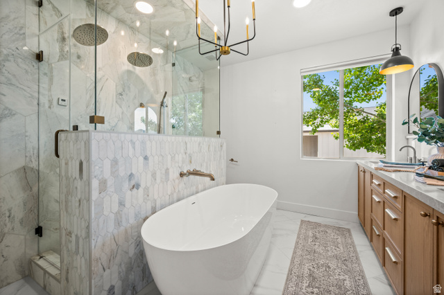 4077 Rons Court Riverton, UT 84096 - Photo 19 of 48 Your private retreat awaits, featuring a luxurious steam shower, soaking tub, double vanities, and abundant storage.